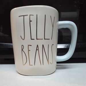 Rae Dunn White Mug With Baby Blue Inside And Gold Writing "Jelly Beans"